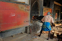 Factory worker stoking the fire, Blu Field Tea Factory, Nuwara Eliya, Sri Lanka. June 2010