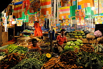 Portraits of young men working on fruit stalls selling of local produce at market, Nuwara Eliya, Sri Lanka, June 2010.