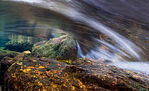 Time-exposure view of flowing freshwater stream  showing water turbulence around rocks, Snowdonia NP, Gwynedd, Wales, UK. December 2009.