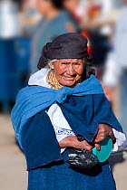 Elderly woman in Indian market in the town of Otavalo, Ecuador. Editorial use only.