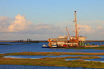 Oil drilling rig in Mississippi River delta salt marsh. Plaquemines Parish, Louisiana. USA, July 2010.