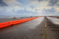 Slickbar oil booms on the beach at Grand Isle, used in the clean up and containment of hazardous oil, from the BP Deepwater Horizon spill in the Gulf of Mexico. Jefferson Parish, Louisiana. USA, July...