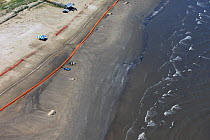 Aerial view of Slickbar oil booms on the beach at Grand Isle, used in the clean up and containment of hazardous oil, from the BP Deepwater Horizon spill in the Gulf of Mexico. Jefferson Parish, Louisi...