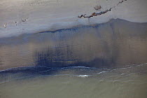 Aerial view of  an oil stained beach, contaminated by the BP Deepwater Horizon oil leak in the Gulf of Mexico. Grand Isle, Jefferson Parish, Louisiana, USA, July 2010.