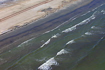 Aerial view of an oil stained beach, contaminated by the BP Deepwater Horizon oil leak in the Gulf of Mexico. Grand Isle, Jefferson Parish, Louisiana, USA, July 2010.