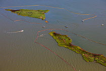 Aerial view of oiled bird nesting colonies in Barataria Bay area of the Mississippi River delta, with oil spill containment booms attempting to prevent more oil coming ashore. These waters are contami...