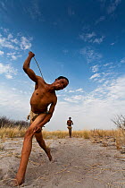 Kalahari bushmen playing traditional game, Kalahari desert, Botswana, September 2009