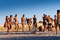 Kalahari bushmen, family group playing skipping game, Central Kalahari Desert, Botswana, August 2008