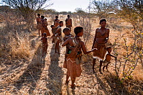 Kalahari bushmen, family group out looking for food in the bush during the dry season, Central Kalahari Desert, Botswana, August 2008
