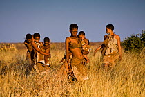 Kalahari bushmen, women walking through long grass, Central Kalahari Desert, Botswana, August 2008