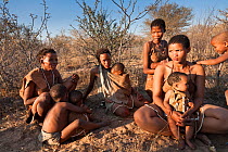Kalahari bushmen, family looking for food in the bush during the dry season. Central Kalahari Desert, Botswana, August 2008