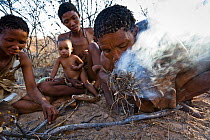 Kalahari bushmen making fire in the bush. Central Kalahari Desert, Botswana, August 2008