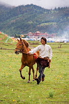 A Khampa warrior leads his Tibetan horse towards the start of the race, during the horse festival, near Huangyan, in the Garze Tibetan Autonomous Prefecture in the Sichuan Province, China, June 2010