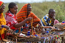 Maasai women selling beaded jewellery and crafts to tourists. Near Masai Mara Reserve, Kenya, East Africa, August 2008