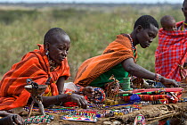 Maasai women selling beaded jewellery and crafts to tourists. Near Masai Mara Reserve, Kenya, East Africa, August 2008