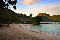 Beach in Pago Pago harbour, with Rainmaker Mountain lit by evening sun, American Samoa, Samoan Islands, August 2008.