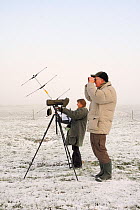 RSPB volunteers Jane Munstermann and Derek Stevenson observing and radio-tracking Common / Eurasian cranes (Grus grus) released by the Great Crane Project onto the Somerset Levels and moors, on a fogg...