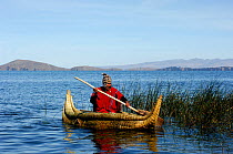 Aymara man on a boat made with Totora (Schoenoplectus californicus ssp. tatora) Titicaca lake, Bolivia, South America 2008