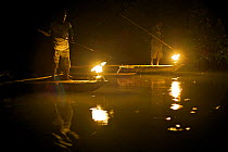 Men spearfishing at night from the bows of canoes in Mayalibit Bay. Waigeo Island, West Papua, Indonesia, April 2007