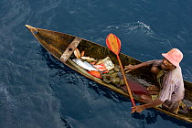 At sea off the Fak Fak Peninsula, a fisherman in a canoe caught a variety of fish including tuna, snappers, and groupers on a hand line. This is a good example of a healthy fishery. West Papua, Indone...