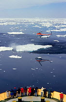 Passengers on a flight in Mi2 helicopter over the bow of ice breaker "Kapitan Khlebnikov". Antarctica, 1998.