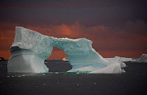 Ice arch in Marguerite Bay at sunset, south of the Antarctic Circle, Antarctica, February 2009.