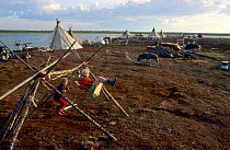 Nenets children playing on home made swing at their summer camp near Nadym. Yamal, Western Siberia, Russia, 2000.