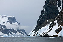 Stratus cloud surrounding the mountains at the side of the Lemaire Channel, Antarctica, February 2009.
