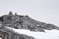 Tourists by the Cairn at Port Charcot, Booth Island, Antarctica, February 2009.