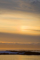 Sundog / Parhelion (circle of light around the sun) at sunset in the Argentine Islands, Antarctica, February 2009.