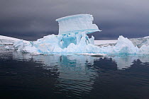 Sculptural iceberg with a large chunk of ice balanced, Fish Islands, Antarctica, February 2009.