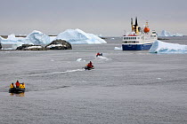 Passengers from the "Ocean Nova" being taken by zodiac to the "Clipper Adventurer". Marguerite Bay, Antarctica, February 2009.