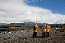 Tourists watching penguins by the landing site on Prion Island, Bay of Isles, South Georgia, 2009.