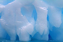 Blue iceberg rounded by sea water, Antarctica, 2009.