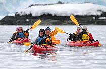 Tourists in double kayaks in Mikkelsen Harbour, Trinity Island, Antarctica, 2009.