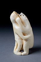 Figure of inuit hunter fighting polar bear carved from walrus ivory. Thule, Northwest Greenland.