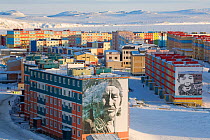 Murals of native Chukchi on the side of brightly coloured appartment blocks in the town of Anadyr. Chukotka, Siberia, Russia, spring 2010