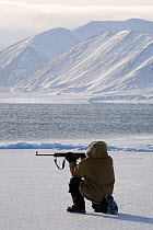 Yupik Eskimo hunter shooting seal from the floe edge in Tkachen Bay. Chukotskiy Peninsula, Chukotka, Siberia, Russia, 2010