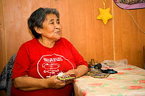 Yupik Eskimo woman sewing at her home in new Chaplino. Chukotskiy Peninsula, Chukotka, Siberia, Russia, 2010