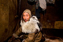 Chukchi reinder herder inside his Yaranga (traditional tent). Chukotskiy Peninsula, Chukotka, Siberia, Russia, 2010
