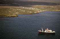 Aerial view of Port aux Francais, scientific station and Marion Dufresne cargo ship in Morbihan gulf. Kerguelen archipelago, Sub-antarctic, Territory of the French Southern and Antarctic Lands, Decemb...