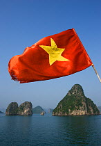 Vietnamese flag flying over Ha Long Bay, Unesco World Heritage Site, Quang Ninh Province, Vietnam.