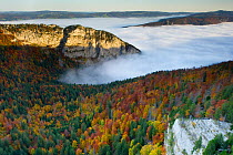 The Creux du Van cirque, an amphitheatre-like valley head shaped by glacial erosion. Seen in autumn, partly hidden by clouds. Switzerland