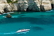 Speed boat passing the Rocky coast of Cala Macarella, Menorca, Balearic Islands, Spain, Mediterranean, July 2005