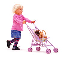 Young girl playing with rabbits in a buggy. Model released
