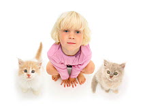 Portrait of young blonde girl, with two kittens looking up. Model released