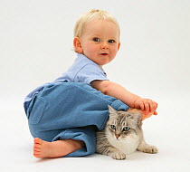 Portrait of toddler sitting with Bengal cat. Model released