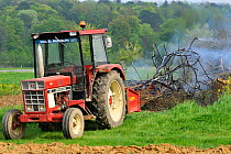 Hedgerow being scrubbed up and burnt on fire in spring, Lorraine, France, April 2009