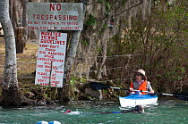 A volunteer warden patrols Three Sisters Spring, home to many of the Florida manatees (Trichechus manatus latirostrus) Crystal River, Florida, USA. February 2010