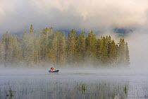 A canoeist in early morning mist on East Inlet, Pittsburg, New Hampshire, USA. A pond upstream from Second Connecticut Lake, July 2007